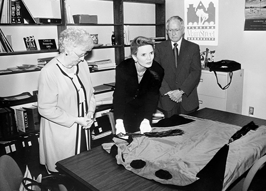 Trish Clements receiving the inaugural gown of First Lady Maude Hardee
