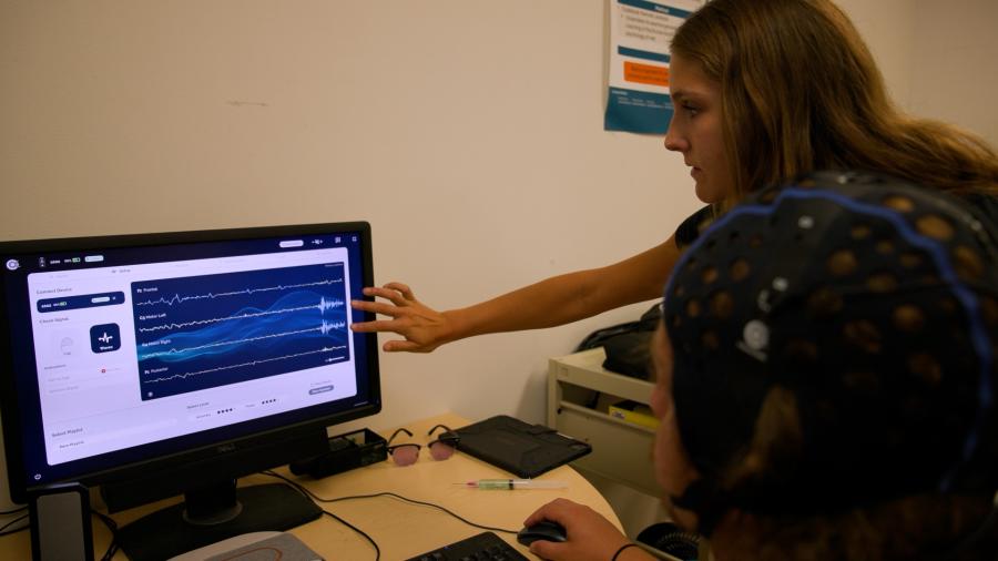 woman observing brain activity on a screen