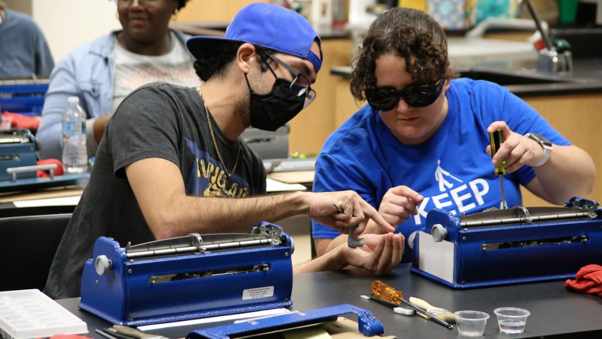 students repairing Brailler