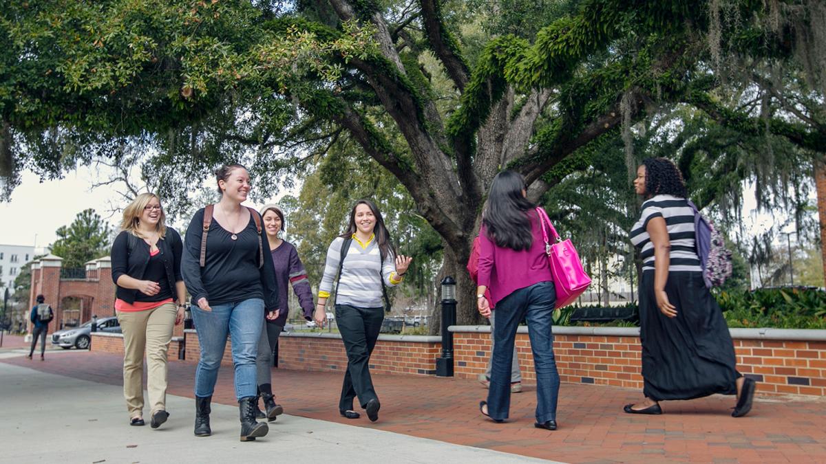 students in front of Stone Building