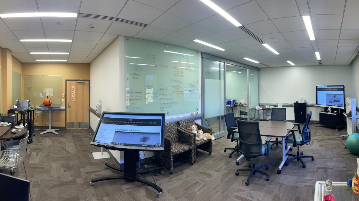 Panoramic photo of room filled with a variety of learning technologies