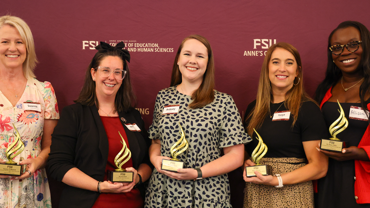 Award recipients pose together with their awards