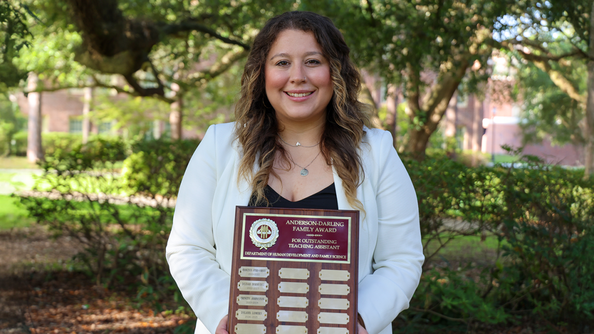 Dylann Lowery holds the Anderson Darling Award plaque