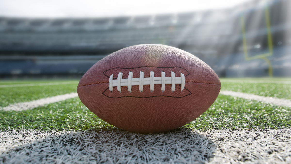 close-up of a football on the field of an empty football stadium