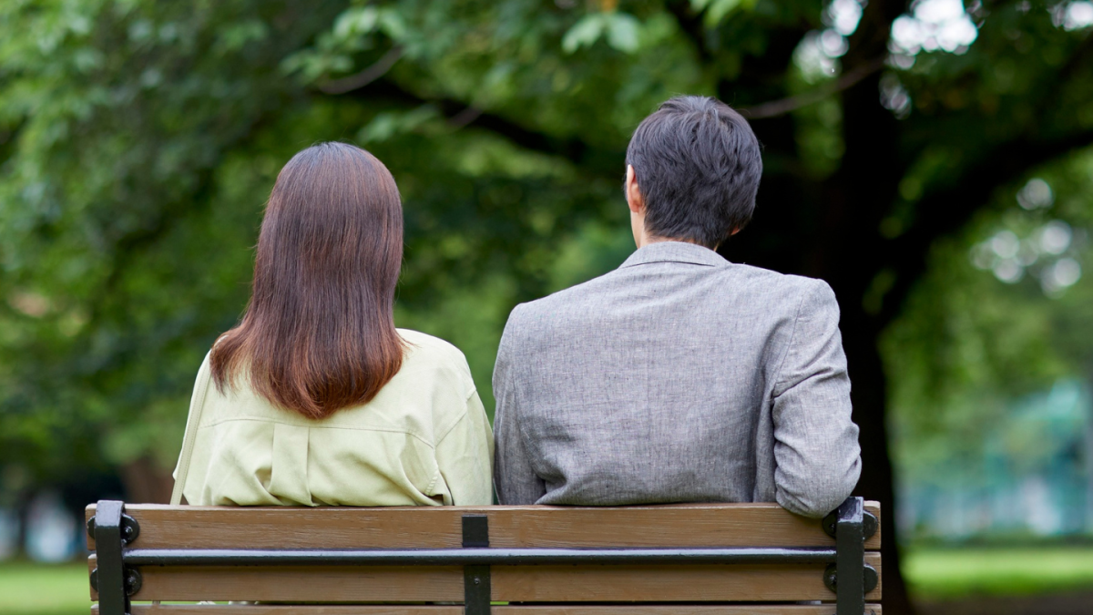 couple sitting together on a park bench