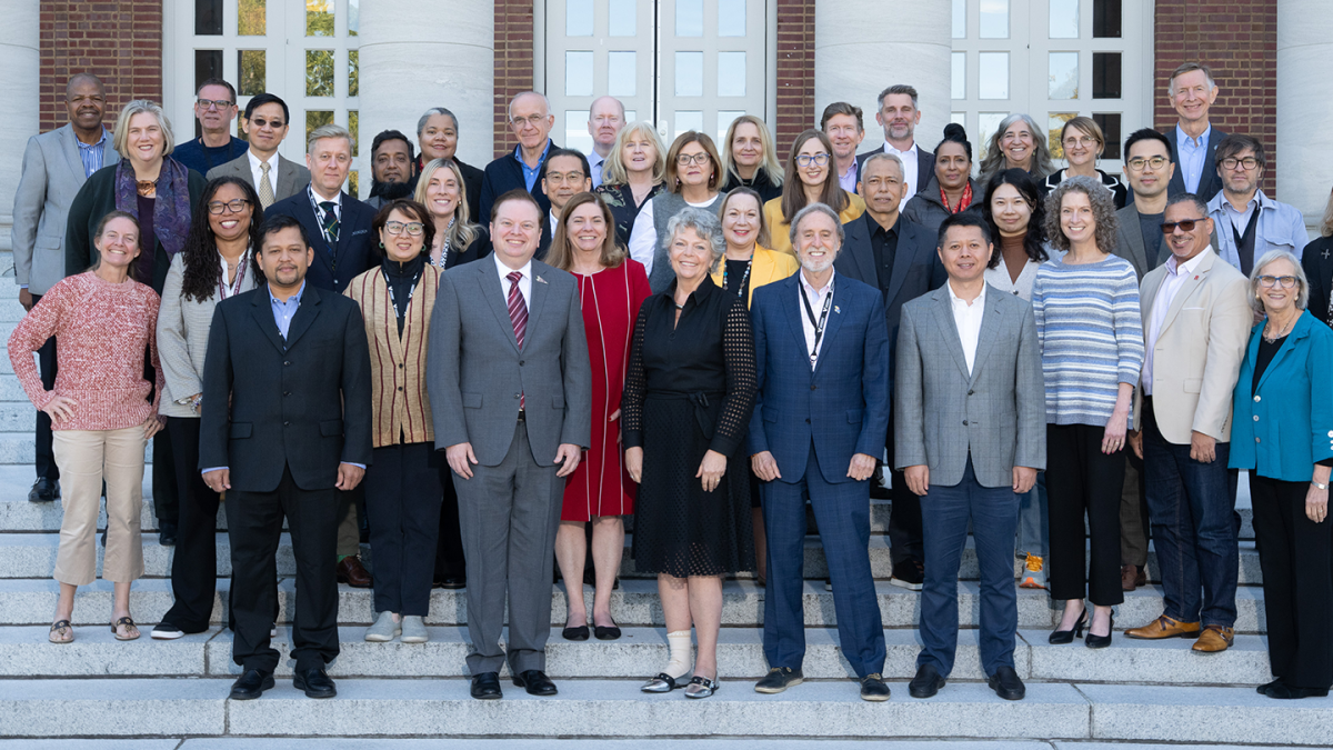 Group photo of GEDF attendees on an outdoor staircase