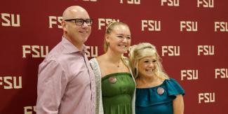 Family in front of FSU backdrop