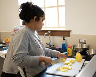 Dietetic student chopping potato