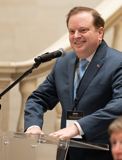 Damon Andrew speaking at a podium
